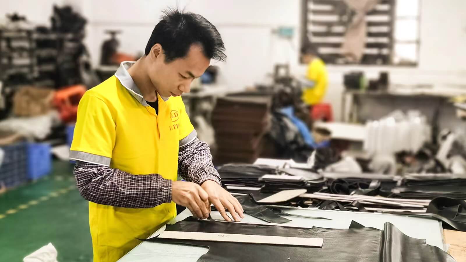 Men's Leather Bag Master is cutting leather